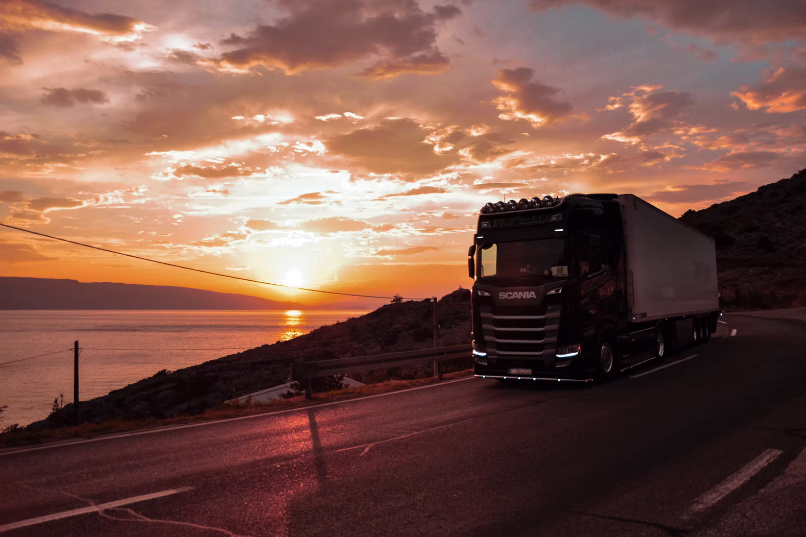 Truck travelling at sunset